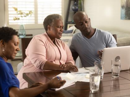 An image of a Family Looking at a Computer